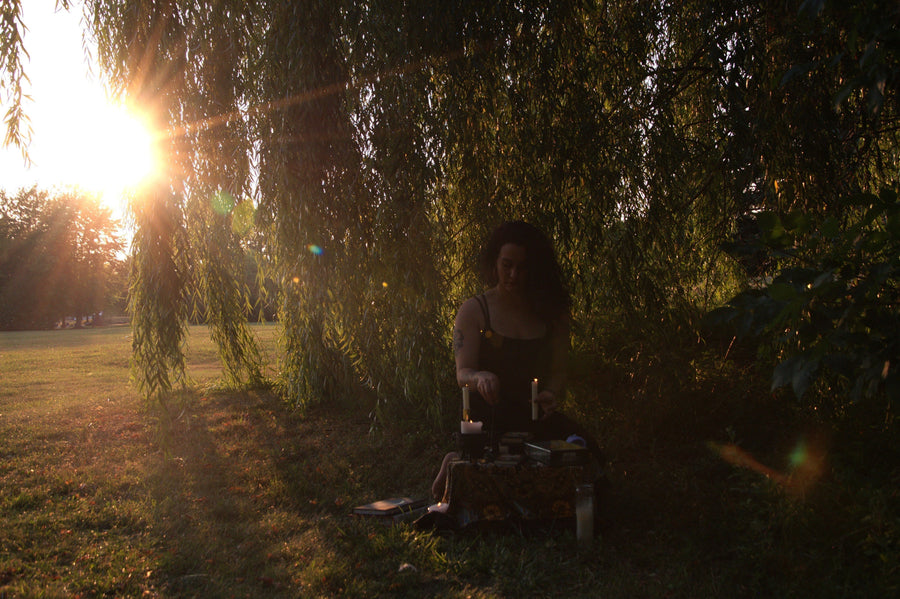 Woman resting with a cup of tea in soft morning light