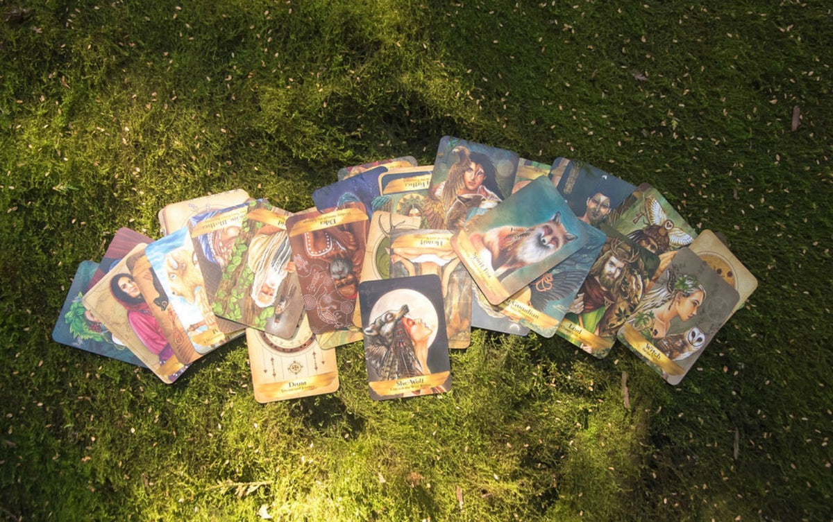 Tarot cards laid out on a table for a reading with Ascending Priestess